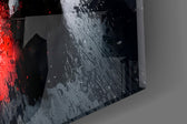 Close-up detail of the red rear light glow reflected on wet asphalt on the glass surface