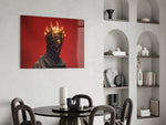 faceless figure with a glowing thorn crown glass wall art leaning beside a dark leather sofa