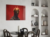 faceless figure with a glowing thorn crown glass wall art leaning beside a dark leather sofa
