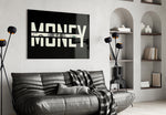 money typography with a hundred dollar bill glass wall art styled above an armchair in a reading corner