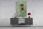 a reader lounging on a windowsill glass wall art styled in an atmospheric room setting
