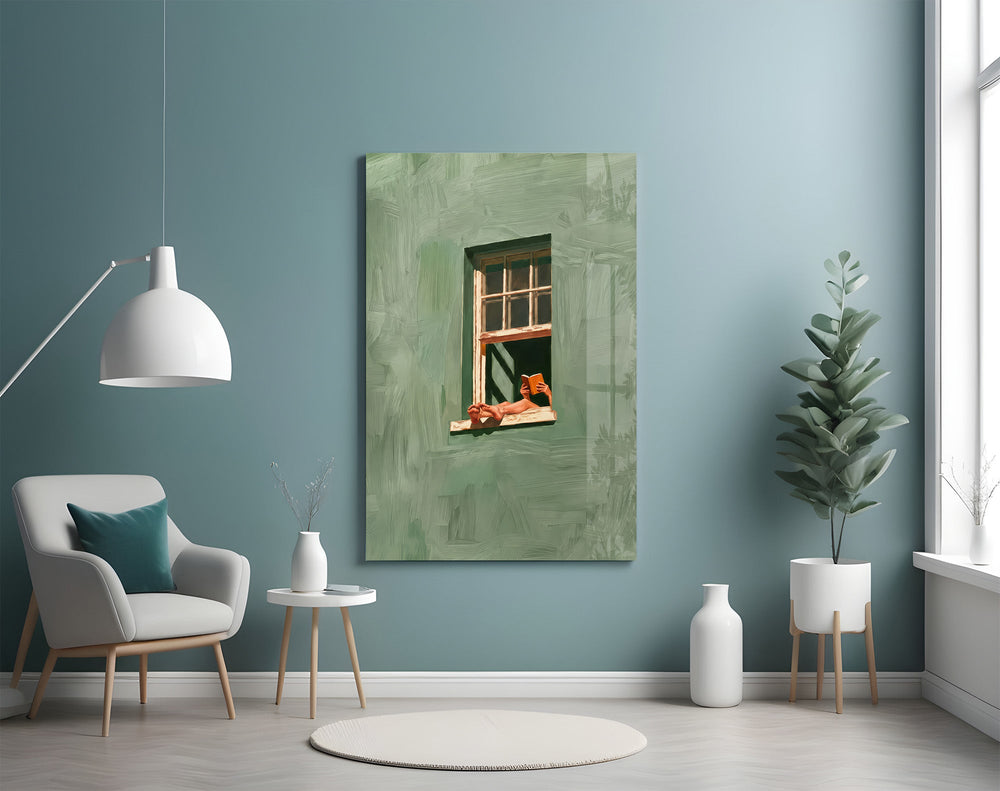 a reader lounging on a windowsill glass wall art styled above an armchair in a reading corner