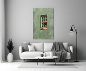 a reader lounging on a windowsill panel bringing character to a minimalist living room wall