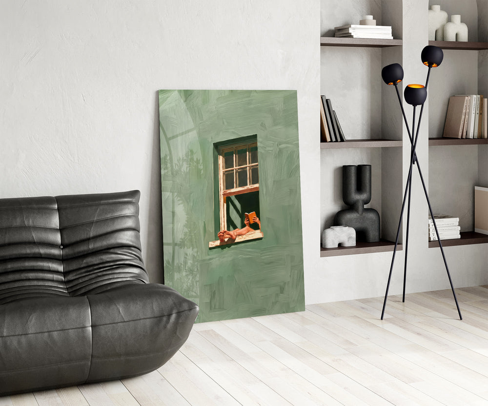 a reader lounging on a windowsill glass wall art leaning beside a dark leather sofa