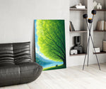 two friends beneath a sprawling tree glass wall art leaning beside a dark leather sofa