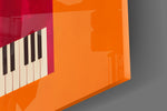 Close-up detail of the black and white keyboard against the crimson case on the glass surface
