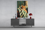 sleeping ginger cat in a striped blanket glass wall art styled in an atmospheric room setting