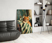 sleeping ginger cat in a striped blanket glass wall art leaning beside a dark leather sofa