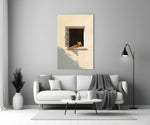 reader's legs in a sunlit window panel bringing character to a minimalist living room wall