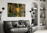 golden forest path through patterned trunks glass wall art styled above an armchair in a reading corner