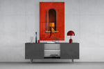 figure reading in a red arched niche glass wall art styled in an atmospheric room setting