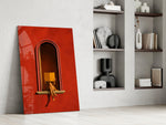 figure reading in a red arched niche panel resting in a shelving niche in a modern interior