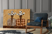 two women in cow-print cowboy hats panel resting in a shelving niche in a modern interior