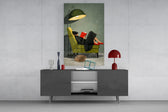 woman reading in a green armchair glass wall art styled in an atmospheric room setting