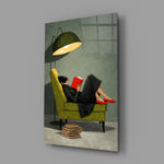 woman reading in a green armchair glass wall art angled to show the polished tempered glass panel