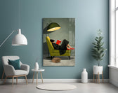 woman reading in a green armchair glass wall art styled above an armchair in a reading corner