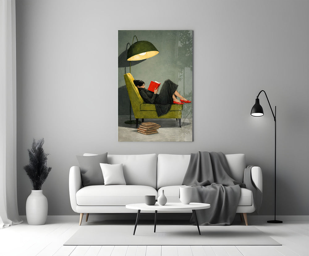 woman reading in a green armchair panel bringing character to a minimalist living room wall
