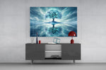 frozen turquoise tree in a winter landscape glass wall art styled in an atmospheric room setting