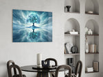 frozen turquoise tree in a winter landscape glass wall art leaning beside a dark leather sofa
