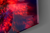 Close-up detail of the deep-red canopy against burning clouds and a blue nebula on the glass surface