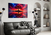 crimson tree under a fiery cosmic sky glass wall art styled above an armchair in a reading corner