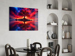 crimson tree under a fiery cosmic sky glass wall art leaning beside a dark leather sofa