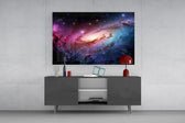 a pink and blue spiral galaxy glass wall art styled in an atmospheric room setting