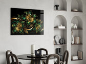 emerald and gold lilies on black glass wall art leaning beside a dark leather sofa