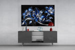 sapphire blue and silver lilies on black glass wall art styled in an atmospheric room setting