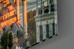 Close-up detail of the sunlit domes and slender minarets on the glass surface