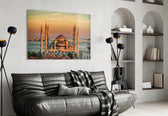 golden sunset six-minaret mosque glass wall art styled above an armchair in a reading corner