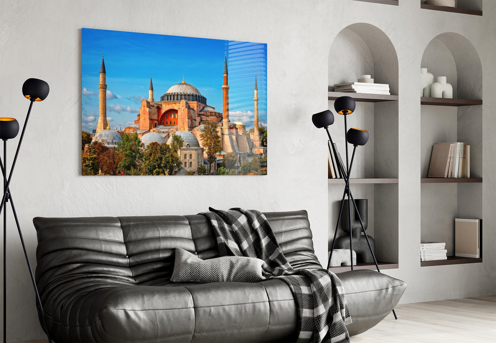 terracotta domed basilica under blue sky glass wall art styled above an armchair in a reading corner