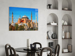 terracotta domed basilica under blue sky glass wall art leaning beside a dark leather sofa