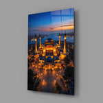 twilight aerial view of an illuminated mosque glass wall art angled to show the polished tempered glass panel