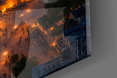 Close-up detail of the floodlit domes and the dusk-lit strait beyond on the glass surface