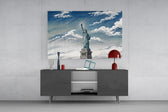 Statue of Liberty glass wall art displayed above a console in a modern interior