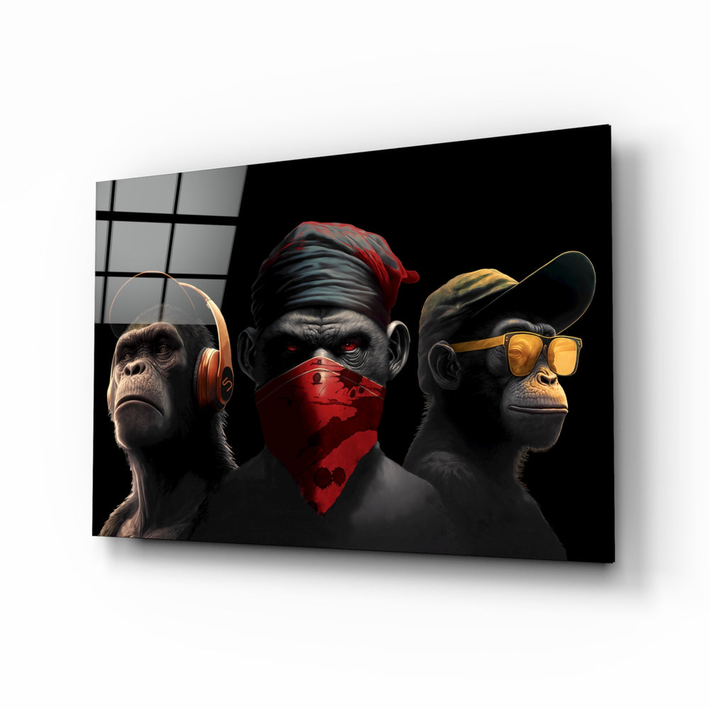 3 Wise Monkey glass wall art displayed above a black leather sectional in a moody man cave with brass sconces