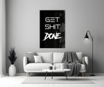 Typographic artwork anchoring a desk wall with white-on-onyx palette