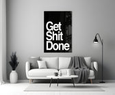 Get Shit Done glass wall art styled above a console in a study