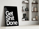 Typographic artwork anchoring a desk wall with white-on-onyx palette