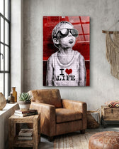 I Love Life glass wall art displayed above a chair in a loft