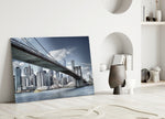 Manhattan Bridge glass wall art styled above a sofa in a modern loft
