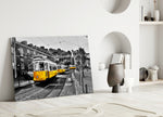 Yellow Tram glass wall art styled above a sofa in a travel-inspired living room