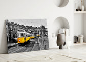 Yellow Tram glass wall art styled above a sofa in a travel-inspired living room