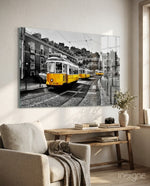Yellow Tram Lisbon glass wall art displayed above a console in a designer interior