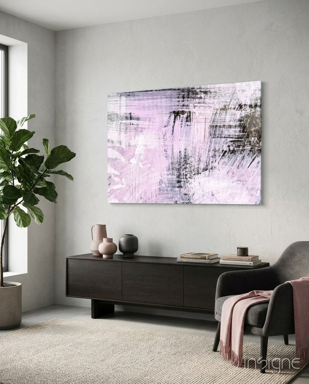Abstract pink and white glass wall art displayed above a console in a designer interior