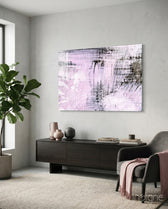 Abstract pink and white glass wall art displayed above a console in a designer interior