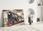 Train glass wall art styled above a leather sofa in a study or library