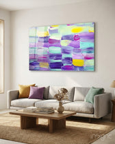 Abstract pastel brushstroke glass wall art displayed above a console in a designer interior