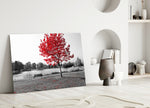 Red Tree glass wall art styled above a sofa in a living room with nature character